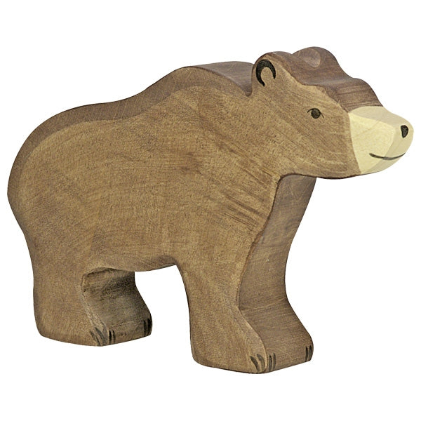 A handcrafted wooden bear figurine with simple carved details and a smooth, polished finish. Made from maple and beech wood, the bear stands with a friendly expression. The visible wood grain adds texture and character to this Holztiger Brown Bear.