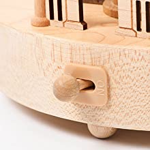 Close-up of a hand cranked Gorilla Music Box crafted from sustainably sourced wood, showcasing detailed wood grain and craftsmanship.