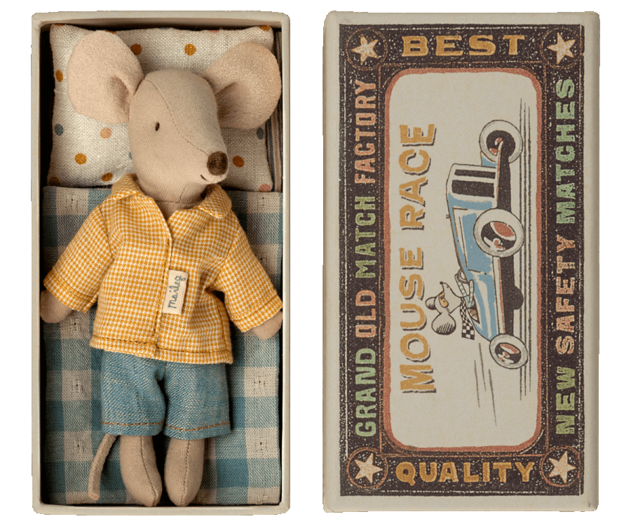 A Maileg Mouse in a box - Big Brother dressed in a yellow checkered polyester shirt and denim shorts, lying in a matchbox with vintage race car graphics, labeled "best mouse race new safety matches".