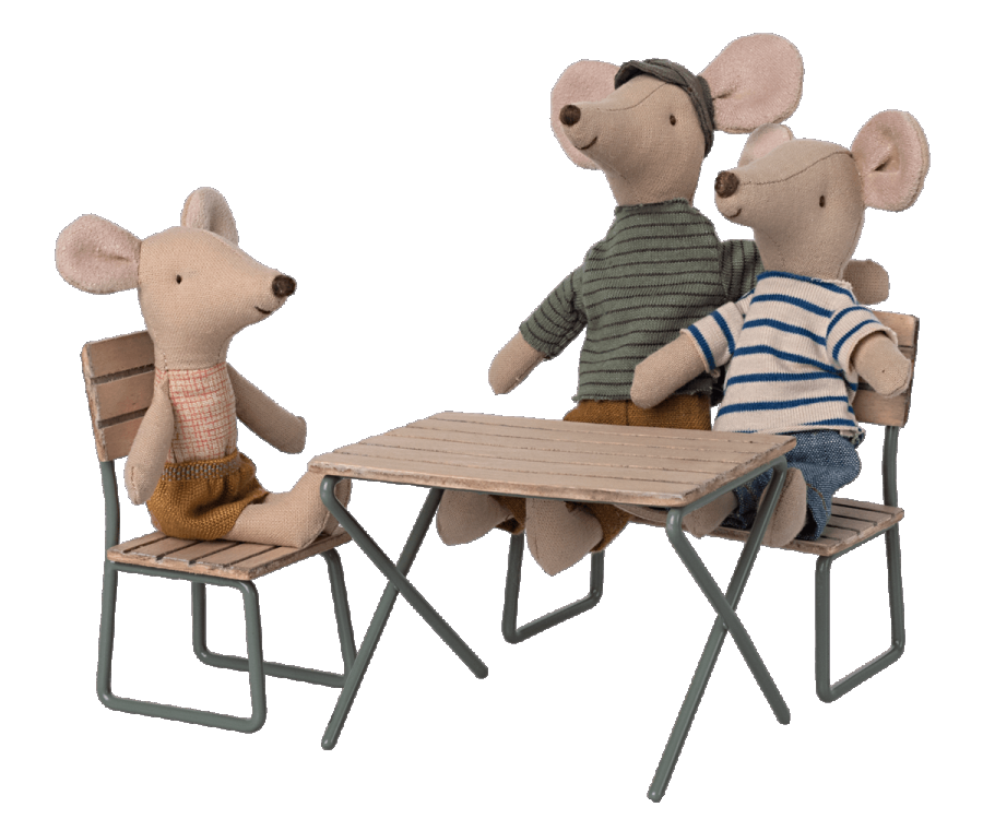 Three stuffed toy mice sitting at a Maileg Garden Table Set with chairs, one facing forward and two facing each other, in casual clothing.