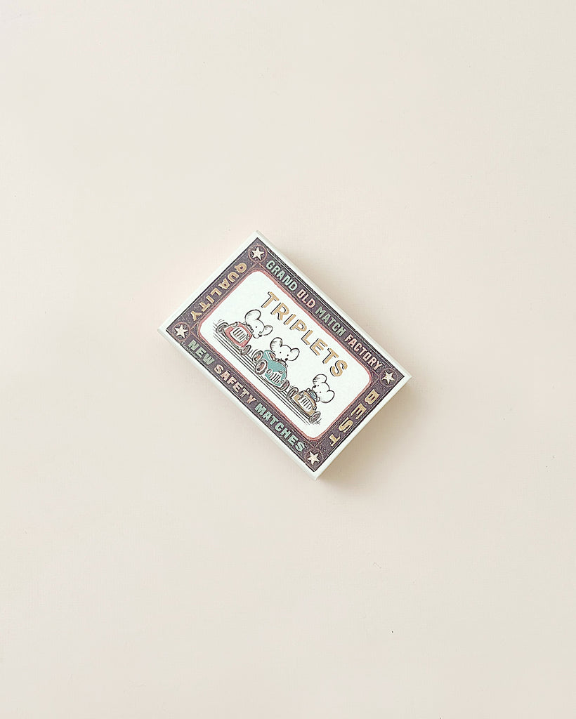 A colorful, whimsical Maileg | Triplets Baby Mice In Matchbox sticker featuring cartoon-style drawings of triplet baby mice dressed cute, with hearts and stars, and the text "rapid weight growth" and "sleep debt alliance" on a plain beige