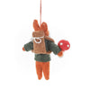 A Handmade Felt Fox Christmas Tree Ornament depicting a cute, cartoon-style fox dressed in green pants and holding a red mushroom. The fox has a white fluffy beard and hangs from a red string.