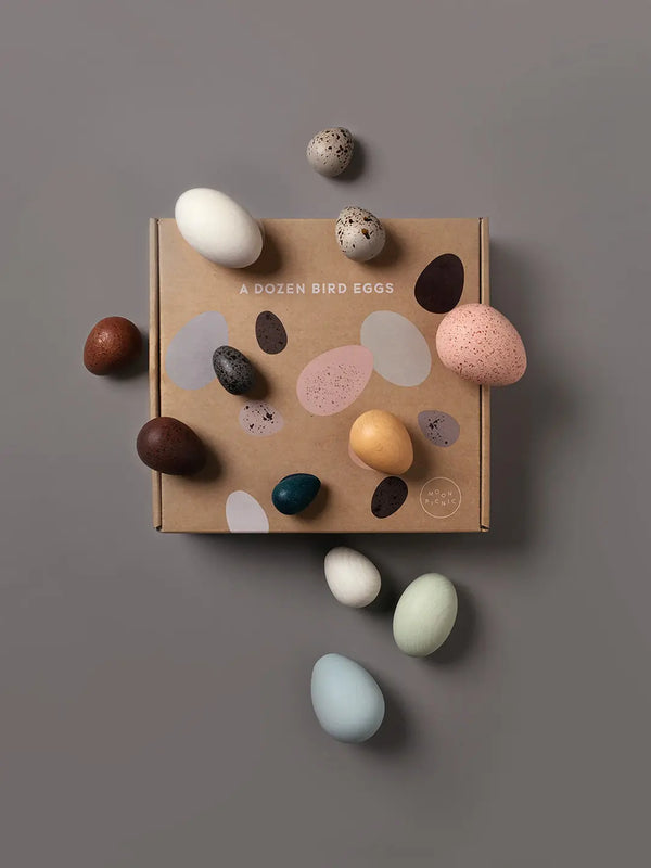 Wooden egg toys on top of a carton box