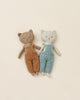 Two Maileg Cat Stuffed Animals from the Best Friends Collection, one in orange overalls and the other in blue, lying side by side against a soft beige background.