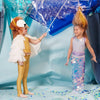 Two children in costumes engaging in imaginative play with a piñata at a party, one dressed as a lion and the other wearing a Meri Meri Mermaid Wrap Costume, surrounded by confetti.