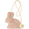 A Meri Meri plush bunny purse with a fluffy pompom tail and a braided rope strap. The bunny is sitting upright, and the bag texture appears soft and fuzzy.
