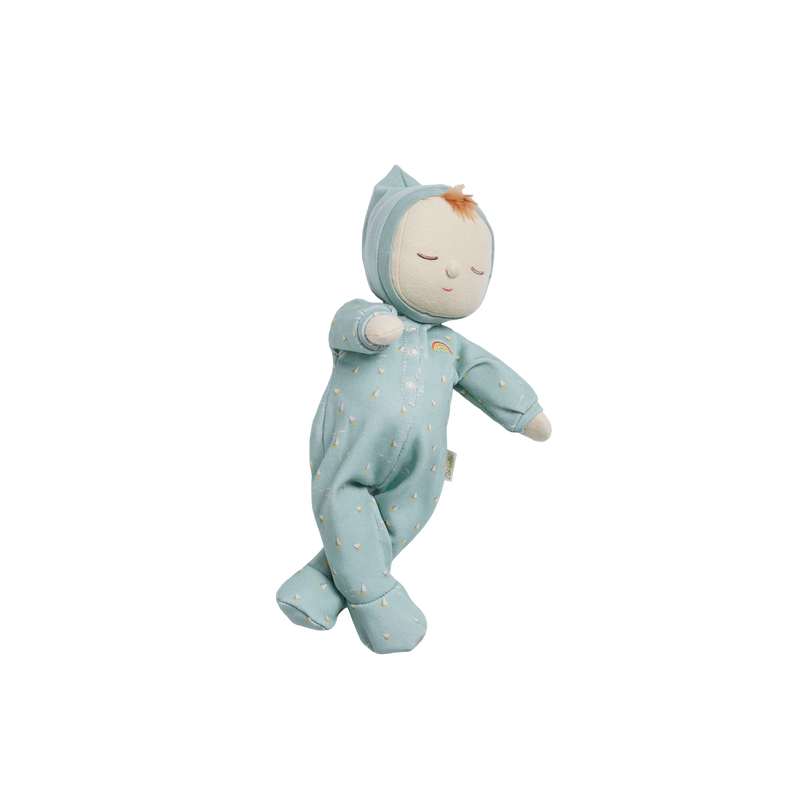 A Daydream Edition Olli Ella Dozy Dinkum Doll dressed in a light blue, star-patterned onesie with a hood, designed to look like a sleeping baby standing up. The doll has a gentle, serene face and soft texture.