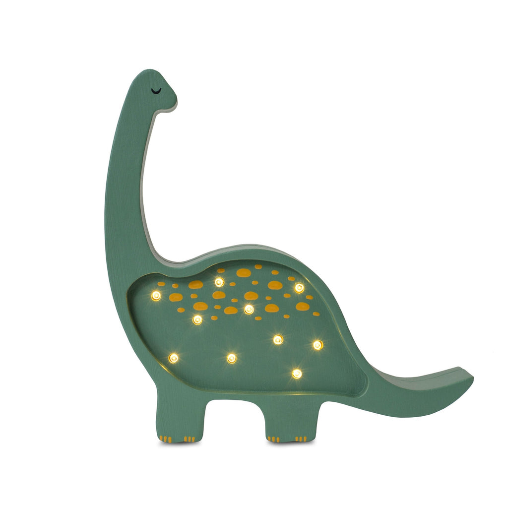 A wooden handmade Small Dinosaur Lamp in green, with a row of small, round, illuminated holes along its body, on a plain white background.