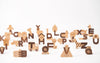 Ultimate Wooden Alphabet Puzzle with animal and object shapes on a white background, including a zebra, truck, and tree.