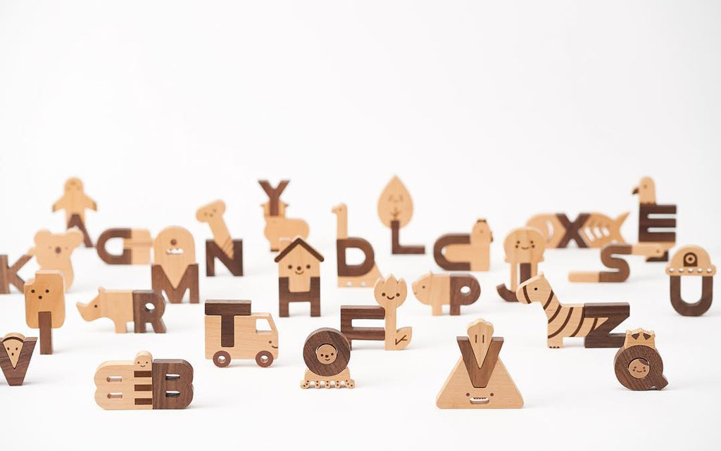 Ultimate Wooden Alphabet Puzzle with animal and object shapes on a white background, including a zebra, truck, and tree.