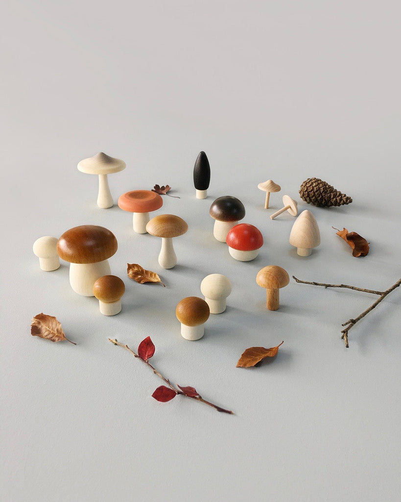 Wooden mushroom toys standing on a flat surface.