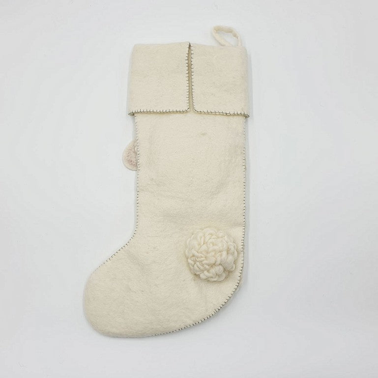 A simple cream-colored Handmade Sheep Christmas stocking with decorative stitches and a floral appliqué on a plain white background.