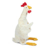 A Senger Naturwelt Cuddly Animal - Chicken crafted from organically grown cotton in a standing pose with outstretched wings, featuring a white body, yellow legs, and red accents on its head and beak, isolated on
